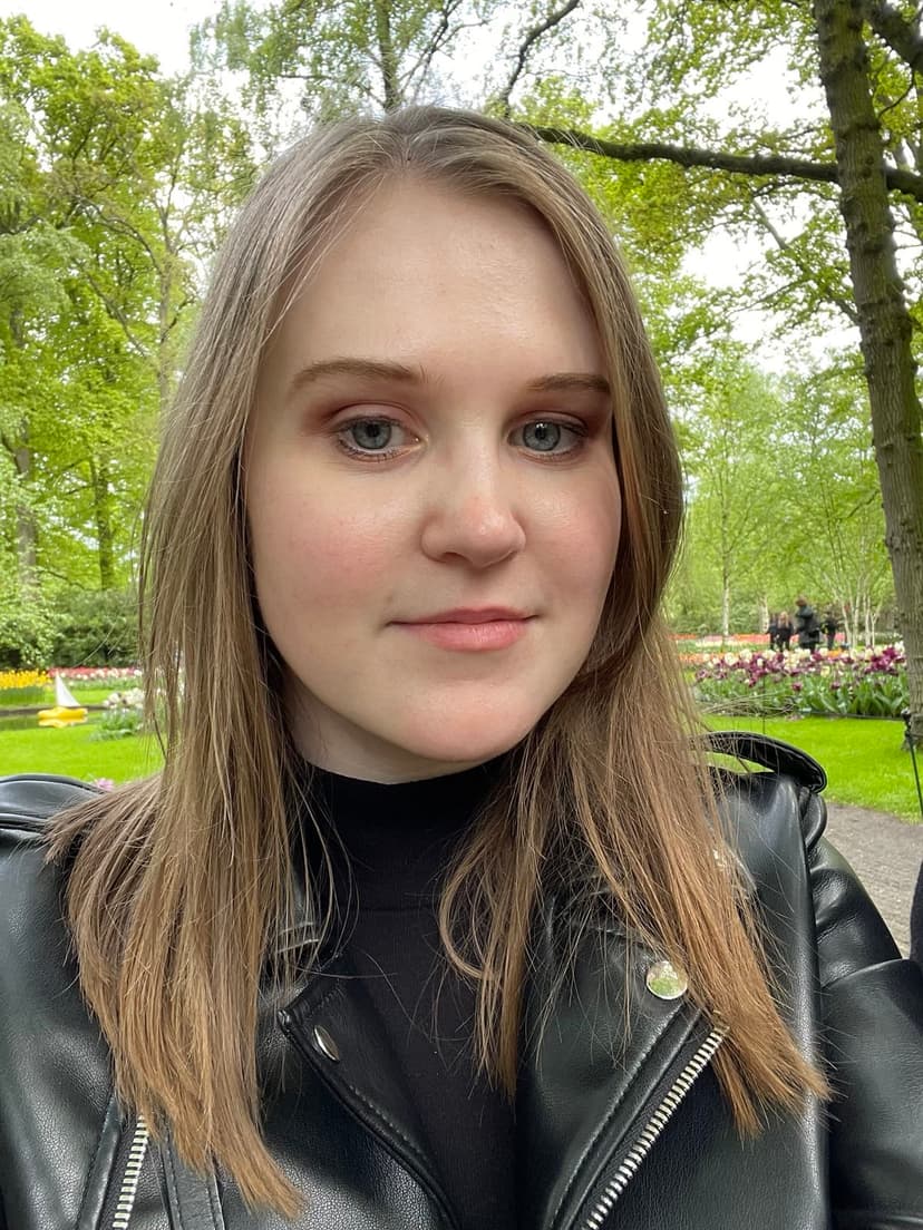 A selfie of Dominika sitting in a park